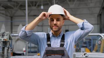 retrato do manual homem trabalhador é em pé com confiante dentro uniforme e segurança capacete às indústria fábrica video