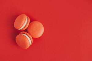 Tasty french macarons on a red background. photo