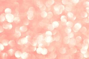 Abstract background in coral color. Shiny glitter bokeh. photo