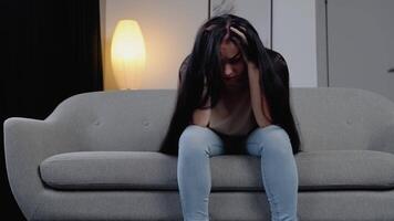 Sad hopeless young woman sit alone at home feeling desperate depressed, upset stressed girl suffer from alcohol abuse drug addiction, dependency, grief or guilt troubled with problems video