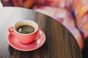 Cup of black coffee on a table in a cafe. photo