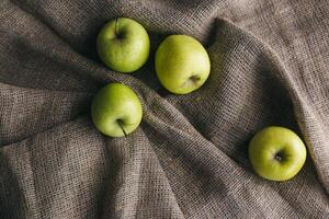 Ripe green apples on a cloth. photo