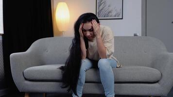 Sad hopeless young woman sit alone at home feeling desperate depressed, upset stressed girl suffer from alcohol abuse drug addiction, dependency, grief or guilt troubled with problems video