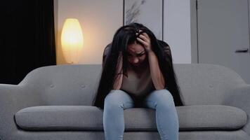 Sad hopeless young woman sit alone at home feeling desperate depressed, upset stressed girl suffer from alcohol abuse drug addiction, dependency, grief or guilt troubled with problems video