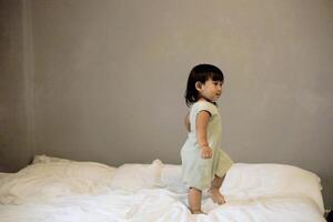 Little Boy Jumping On The Bed photo