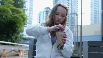 drink bubble tea take selfie Beautiful girl drinks smoothies from a straw in a cafe video