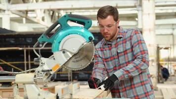 Building contractor worker using hand held worm drive circular saw to cut boards on a new home constructiion project video