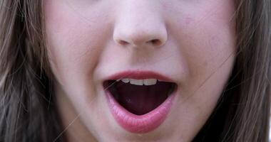 A close-up of the lower part of a girl's face expressing surprise at the camera. Clear complexion and natural lipstick color. video