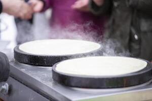 Street food. Fried pancakes in a street cafe. photo