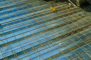 Industrial Photography. Construction works. Textured Background of wiremesh installed on top of the metal deck. Installation of wire mesh on the metal deck before casting the floor. Bandung, Indonesia photo