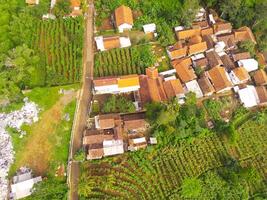 View of residence located on the hillside. Aerial view of residence in a remote area in Cicalengka, Bandung - Indonesia. Above. Housing industry. Shot in drone flying 100 meters photo