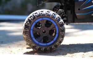 Toys Photography. Closeup Toys. Macrophotography of RC Remote Control Car tires. Closeup shot of tire groove texture with blue rims. Shot with a macro lens photo