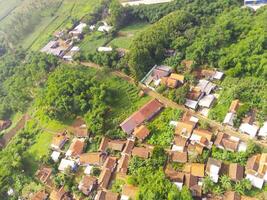 View of residence located on the hillside. Aerial view of residence in a remote area in Cicalengka, Bandung - Indonesia. Above. Housing industry. Shot in drone flying 100 meters photo