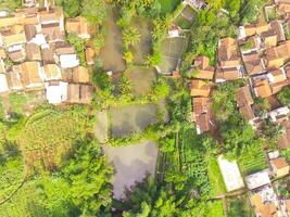 View of residence located on the hillside. Aerial view of residence in a remote area in Cicalengka, Bandung - Indonesia. Above. Housing industry. Shot in drone flying 100 meters photo