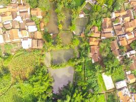 View of residence located on the hillside. Aerial view of residence in a remote area in Cicalengka, Bandung - Indonesia. Above. Housing industry. Shot in drone flying 100 meters photo