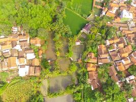 View of residence located on the hillside. Aerial view of residence in a remote area in Cicalengka, Bandung - Indonesia. Above. Housing industry. Shot in drone flying 100 meters photo