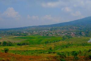 Landscape Photography. Landscape View. Scenic Nature Green and fertile hillsides. Beautiful hill landscape with blue sky background. Bandung, Indonesia photo