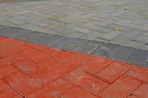 Background Photography. Textured Backgrounds. Detail of road texture with paving blocks. Square paving blocks painted in gray and red. Bandung, Indonesia photo