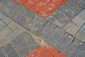 Background Photography. Textured Backgrounds. Detail of road texture with paving blocks. Square paving blocks painted in gray and red. Bandung, Indonesia photo