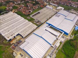 Snack Factory on the outskirts of town. Aerial view of factory in mountain valley, Bandung - Indonesia. Food Industry. Above. Aerial Landscapes. Shot from a drone. photo