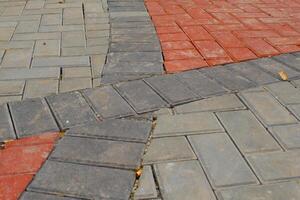 Background Photography. Textured Backgrounds. Detail of road texture with paving blocks. Square paving blocks painted in gray and red. Bandung, Indonesia photo