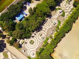 Aerial shot of city park with beautiful floor patterns and trees. Textured Background floor pattern. Aerial photography. Textured details. Shot from a flying drone photo