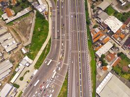 Bird eye view of Vehicle queue at the Purbaleunyi toll gate, due to the surge in travelers during the holiday season, Bandung, West Java Indonesia, Asia. Transportation Industry. Top view. Aerial Shot photo