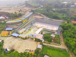 Aerial Photography. Landscape view from above the empty swimming pool. The swimming pool is deserted, uninhabited and dirty. Shot from a drone flying 200 meters high photo