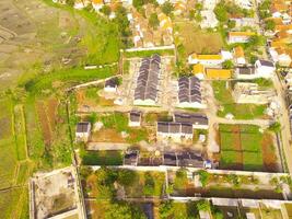 Top view Small Housing. Aerial Photography. Aerial panorama over small isolated housing complex. Shot from a drone flying 200 meters high. Cikancung, Indonesia photo