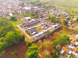 Top view Small Housing. Aerial Photography. Aerial panorama over small isolated housing complex. Shot from a drone flying 200 meters high. Cikancung, Indonesia photo