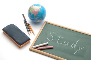 chalkboard with a globe, pencils, lacquered and a slate photo