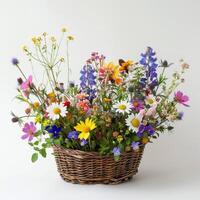 Rustic wicker basket filled with colorful wildflowers. photo