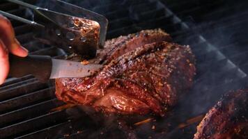 cooking steaks on the fire in real Close-up view of juicy cooked slices of meat with flames. original dish recipe. Professional cooking, food recipe, cooking. Horizontal . Top view. video