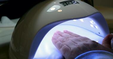 Close up shot of a woman in a nail salon receiving manicure by beautician with metal nail file. Woman getting nail manicure at spa centre. Beautician file nails to a customer in luxury salon. video