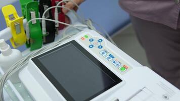 A cardiologist makes a cardiogram to a patient. Female hands of a professional doctor hold a cardiogram for further examination of a sick man in a modern clinic. The latest technologies in medicine. video