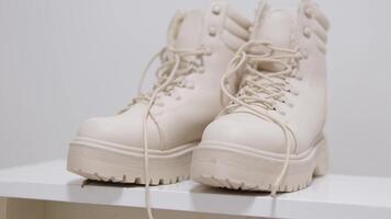 Closeup view spraying water on white color winter shoe protected with waterproof spray video