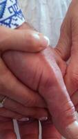 holding hands middle aged adults wedding close up male and female hand in white clothes with blue embroidery on the sleeve working hands video