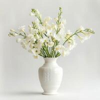 A porcelain vase holds a bouquet of fragrant freesia flowers. photo