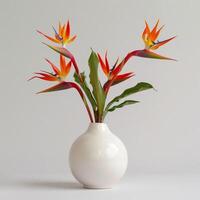 Contemporary ceramic vase shows a group of birds of paradise in bloom. photo