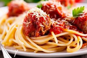 Spaghetti topped with rich tomato sauce and meatballs photo