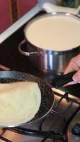 Fry pancakes toss in a frying pan chef tossing pancake in frying pan in kitchen closeup video