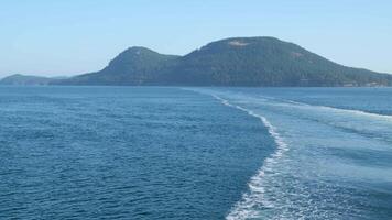 Establishing shot of water trail view from ferry with blue sky and white clouds in slow motion at summer day in Vancouver, Canada, North America. Day time video