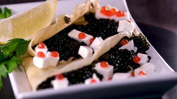 Red and black caviar Feta cheese serving a delicious appetizer dish in a restaurant video