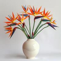 Contemporary ceramic vase shows a group of birds of paradise in bloom. photo