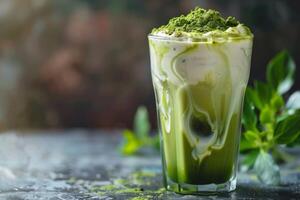 Iced matcha tea in a tall glass with milk. Sprinkle with matcha powder. photo
