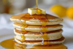 Stack of fluffy pancakes With butter and maple syrup photo