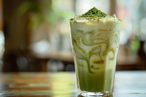 Iced matcha tea in a tall glass with milk. Sprinkle with matcha powder. photo