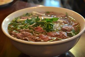 Pho with fragrant broth, rice noodles and tender beef pieces photo