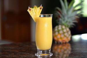 Fruity mango-pineapple smoothie in a tall glass photo