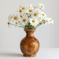 Handmade wooden vase showing a bouquet of daisies. photo